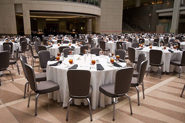 large room set up for a banquet round tables picture id178992732